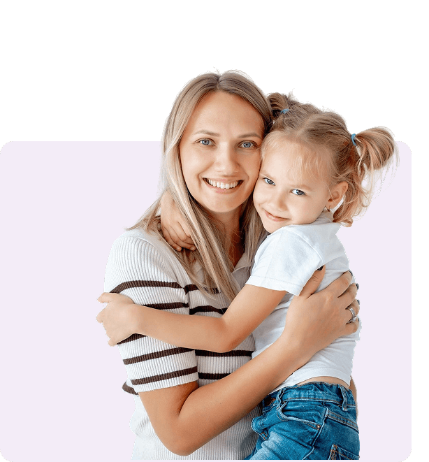 A mother and daughter hugging and smiling.