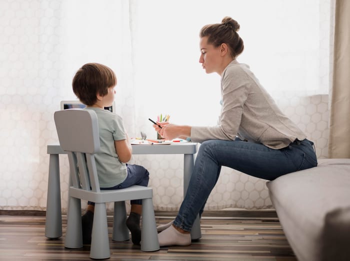 A therapist working with a child at home